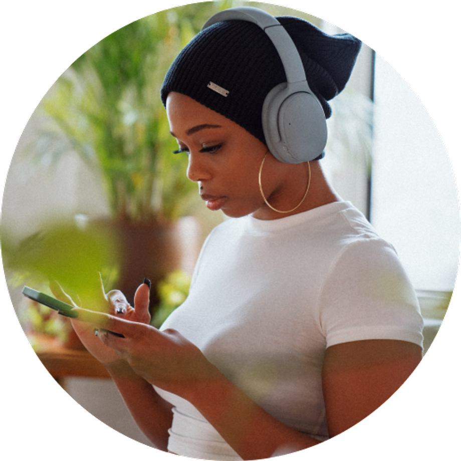 Black woman using headphones and her cellphone