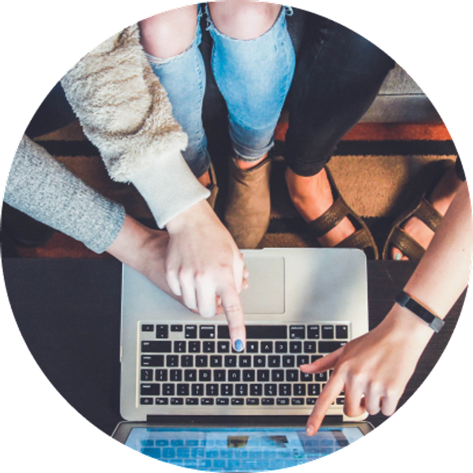 Top view of three people pointing to a computer screen