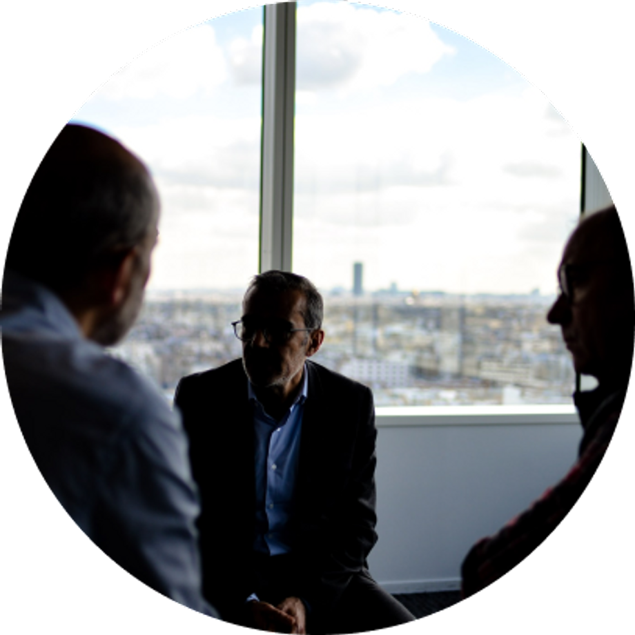 Three men having a meeting