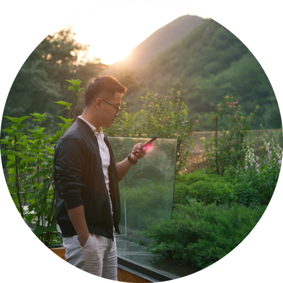 Asian man using a cellphone in a nature background