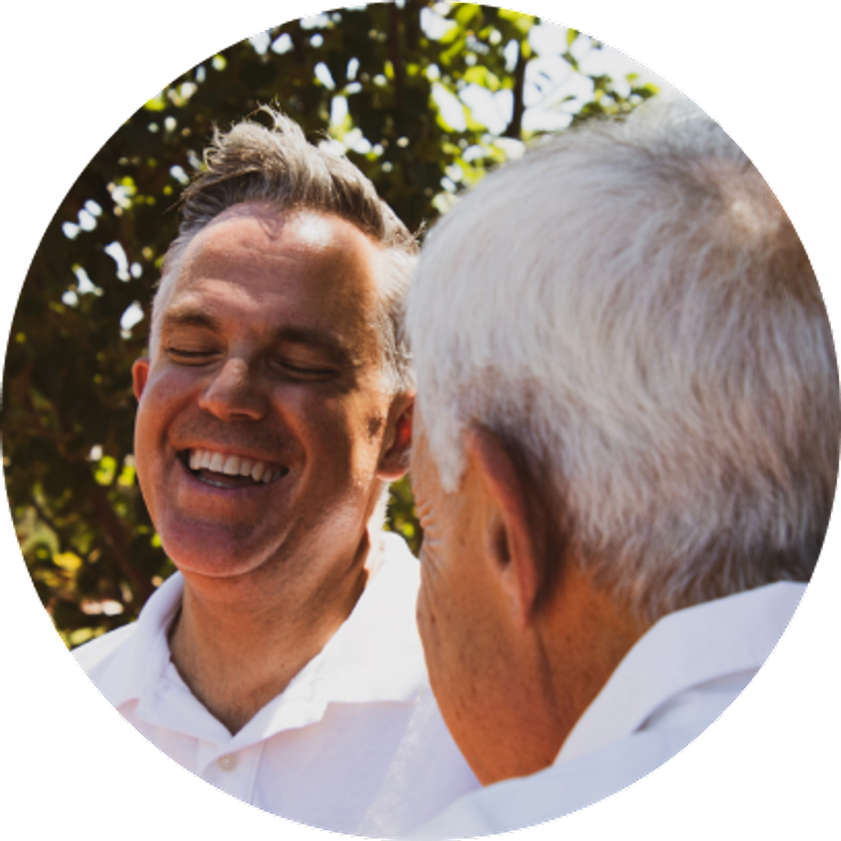 Two older men laughing together