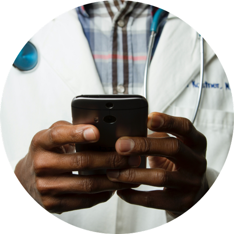 Hands of a black doctor man using a cellphone