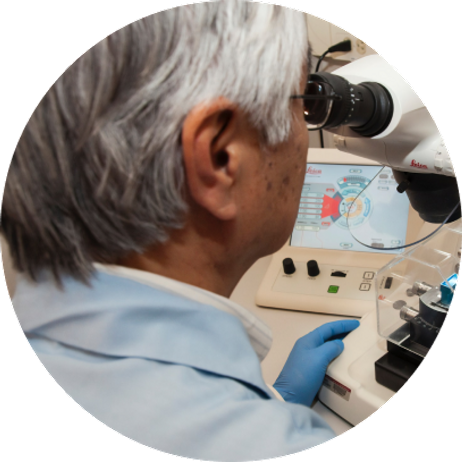 Senior researcher using a microscope