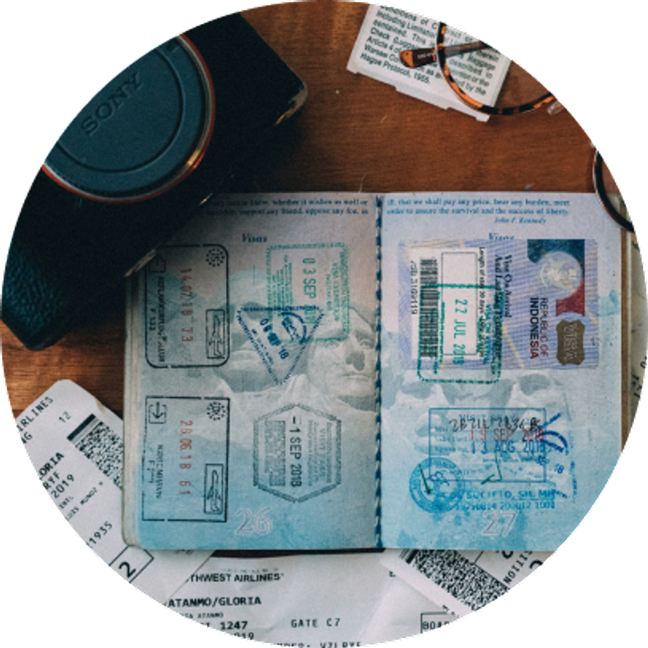 Passport document with a camera and glasses on a table