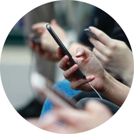 Various hands holding cellphones