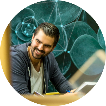 Smiling white man holding a notebook