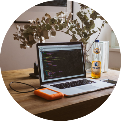Table with an open laptop computer showing developer codes