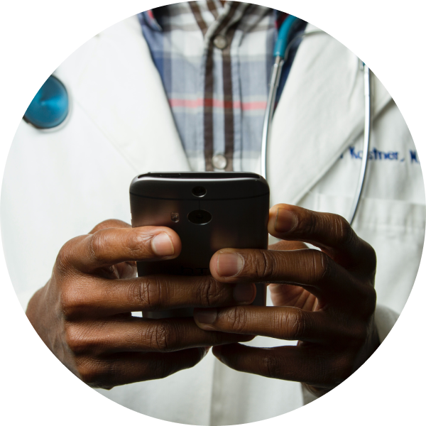Hands of a black doctor man using a cellphone